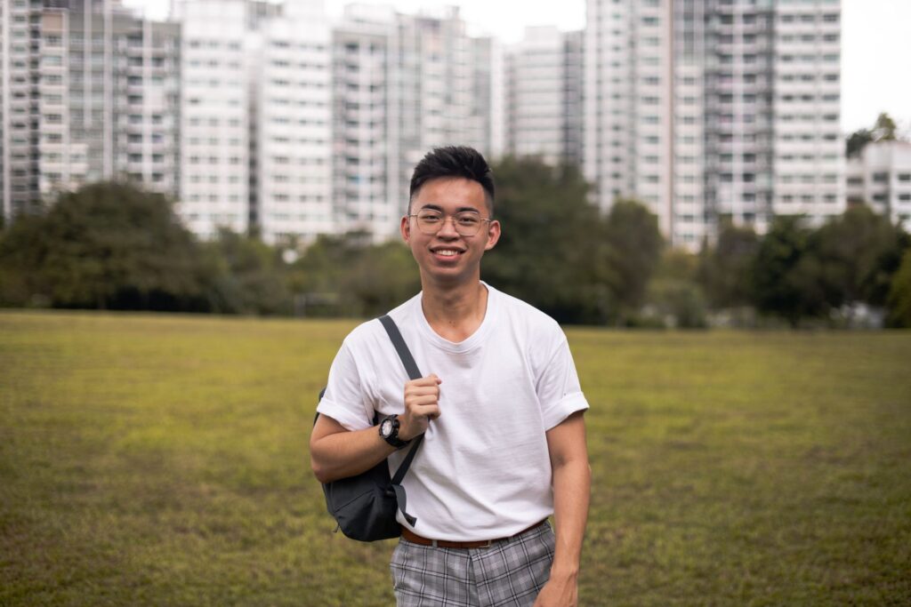 a student with a bag smiling 
