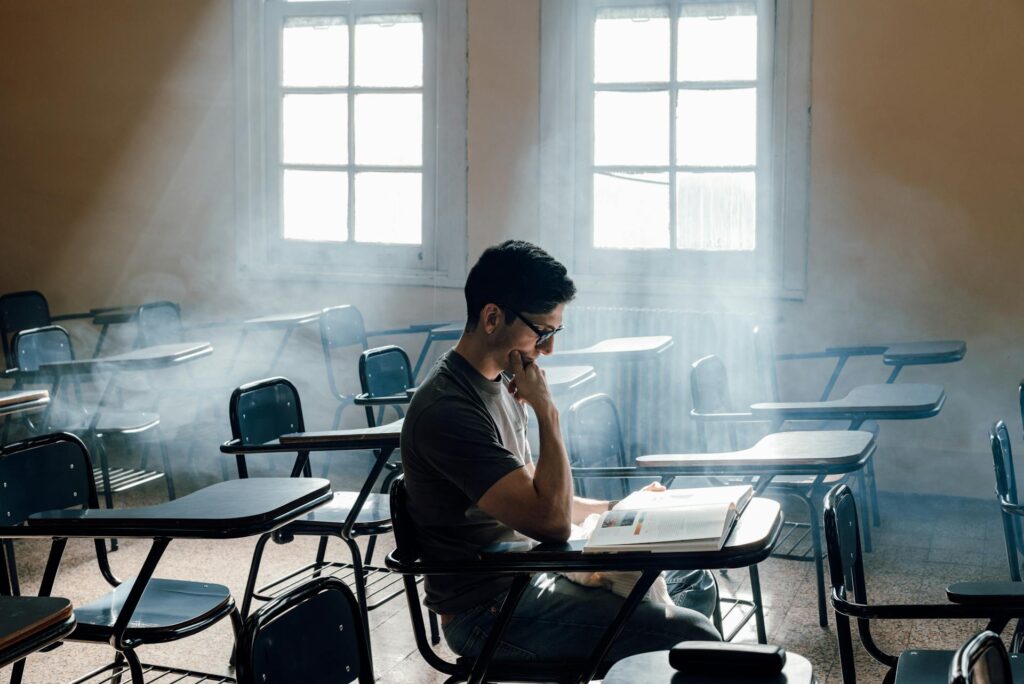 a student is thinking and reading a book