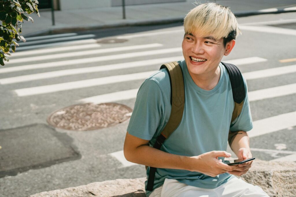 student laughing using phone 