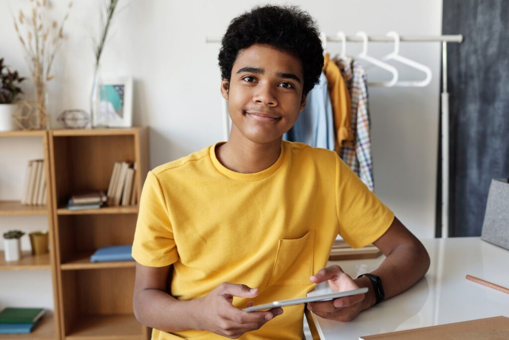 student smiling while using iPad 