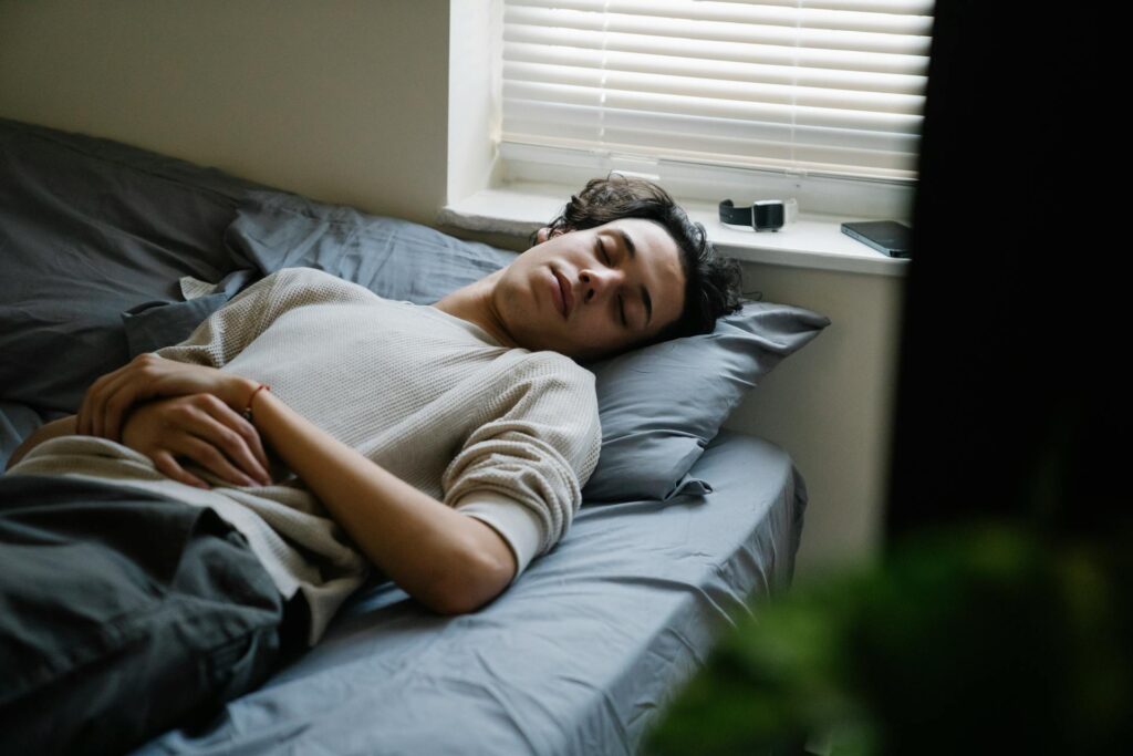 a student is sleeping on bed
