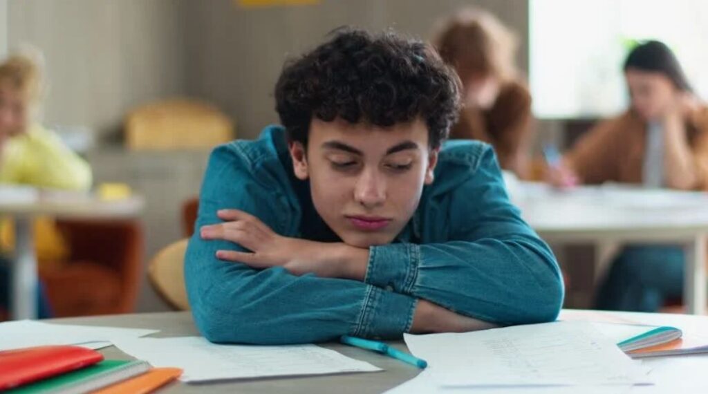 student lay down head on desk 