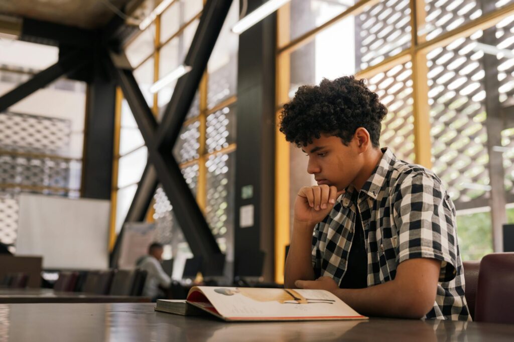 student thinking while reading a book